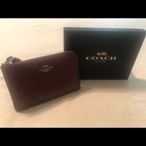 Coach wine color glitter and leather wristlet.